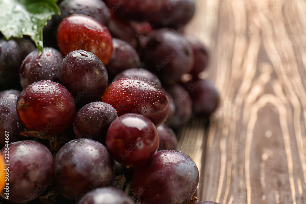 Ripe sweet grapes on wooden table, closeup