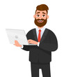 © Illusart - Happy businessman holding and using laptop computer standing against isolated white background.  Technology and laptop computer concept illustration in cartoon vector style.