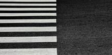 Zebra Crosswalk On A Asphalt Road - Closeup Background