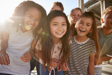 Wall Mural - Elementary school kids smiling to camera at break time