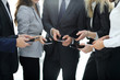 © ASDF - closeup.business team using smartphones .
