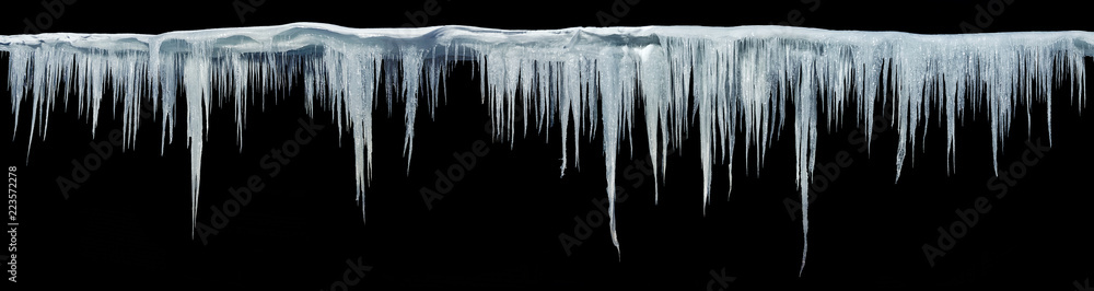 Icicles on an black background, isolated object. Panoramic photo. - obrazy, fototapety, plakaty 