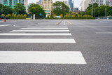 Fototapeta  - Empty parking lot with city in the background