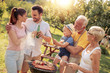 © ivanko80 - Happy family having barbecue party at summer garden