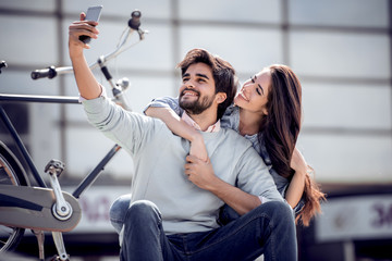 Sticker - Smiling young couple in love taking selfie