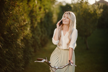 Young sexy blonde girl with long hair standing near vintage whit