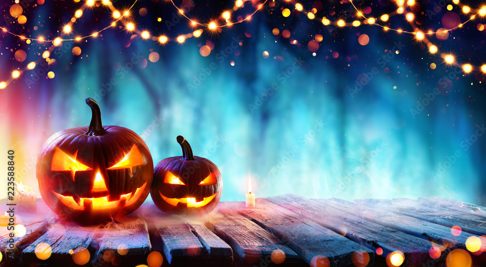 Halloween Party - Pumpkins And String Lights On Table In Dark Forest
 - obrazy, fototapety, plakaty 