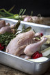 © Cavan Images - Close-up of raw chicken meat with ingredients in tray on table