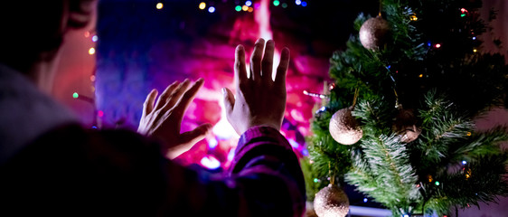 close up wet frozen  teenager under the blanket warm up hands at the home fireplace  f