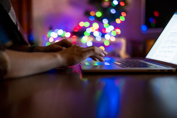 Wall Mural - close up young man working on a laptop at night at home workplace f