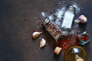 Mix of spices: pepper red, black, white, salt and paprika on a concrete background. Food background - spices.