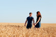 © ShevarevAlex - young loving couple in nature in summer on a background of field with oats