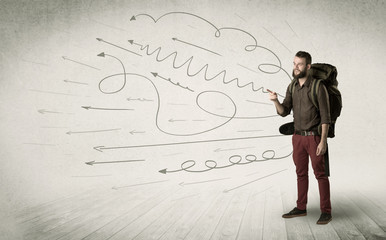 Wall Mural - Handsome young man standing with a backpack on his back and scribbles in the background