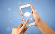 © ra2 studio - Female fingers touching smartphone with cloud concept