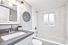 Modern Bathroom Interior With White Vanity Topped With Gray Countertop