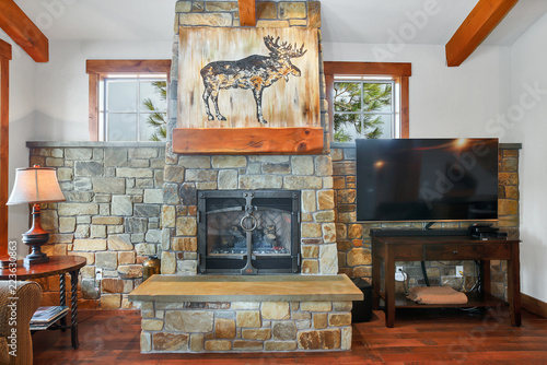 Living Room Interior With Real Stone Fireplace And Wooden Beams