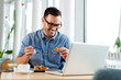 © zorandim75 - Cheerful businessman eating food in restaurant