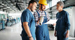 © NDABCREATIVITY - Team Of Engineers Having Discussion In Factory