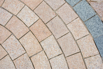 Pavement laid out with yellow and gray stones for decoration in the city