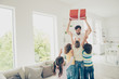 Daddy hold prize above head, four children up from cozy, comfort