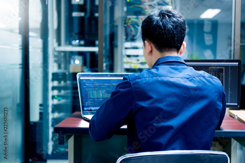 Fotografía Young IT engineer working at server room is Multi Display, Data Protection Security Privacy Concept