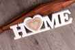 © kelifamily - Word Home in white letters on dark wooden background