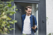 © ReeldealHD images - Adult male leaving the house and checking smartphone