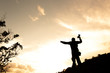 © freedom_naruk - Silhouette of man hold up hands on the peak of mountain,success concept