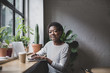 © ReeldealHD images - Portrait of a freelance african american businesswoman working in a cafe