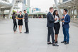 © shutterdemon - business people standing in the city and discussing ideas for business future. multi culture of business people, African, Caucasian and Asian.