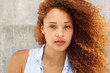 © mimagephotos - Close up beautiful young woman with curly hair staring