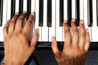 © mimagephotos - top view of female hands playing piano