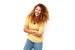 © mimagephotos - beautiful young woman with curly hair laughing with arms crossed against white background