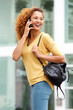 © mimagephotos - attractive young woman talking on mobile phone in the city