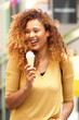 © mimagephotos - happy young woman laughing with ice cream