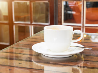 coffee cup white On the glass table wooden and a cement wall background. copy space