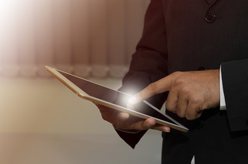 Finger pointing to the businessman's tablet