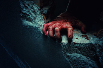 Fototapeta horror scene with bloody hand of evil is coming from a dark hole.