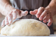 © golubovy - breadmaking process. food cooking and culinary skills concept. man hands ready to knead dough.
