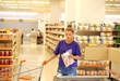 © lado2016 - Woman choosing frozen food from a supermarket freezer