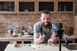 © golubovy - food blogger lifestyle and working process. bearded hipster man video streaming about cooking pie. social network trends and online business concept.