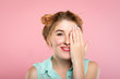 © golubovy - eyesight check. vision examination. woman covering one eye with hand. healthcare and ophthalmology. young beautiful woman portrait on pink background.