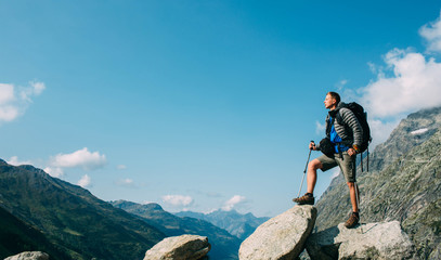 hiker man with a backpack, on the mountain peak near pass grand ferret . hiking around mont blanc, s