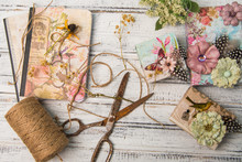 Background With Decorated Gift Boxes, Roll Of Jute And Vintage Scissors