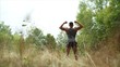 © Ruslan - A handsome, hard-working man is standing in a field. Athlete in the forest.