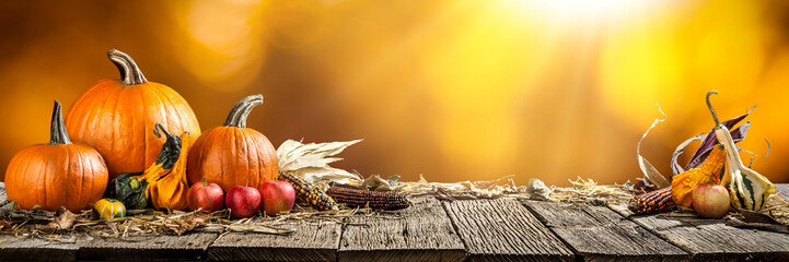 Wall Mural - thanksgiving with pumpkins corncob and apples on wooden table