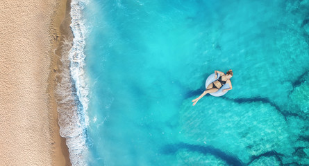 Wall Mural - aerial view at the girl on sea. turquoise water from air as a background from air. natural seascape 