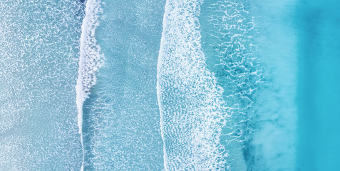 Beach and waves from top view. Turquoise water background from top view. Summer seascape from air. Top view from drone. Travel concept and idea