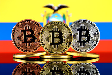 Physical version of Bitcoin (BTC) and Ecuador Flag. Conceptual image for investors in High Technology (Cryptocurrency, Blockchain Technology, Smart Contracts, ICO).