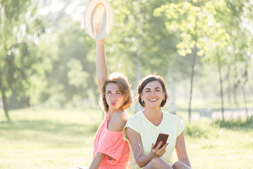 Two girl laughing on grass